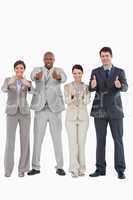 Businessteam giving thumbs up together