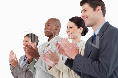 Side view of applauding businessteam standing together