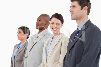 Smiling businesswoman standing between her colleagues