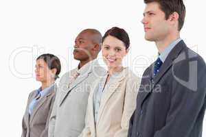 Smiling businesswoman standing between her colleagues