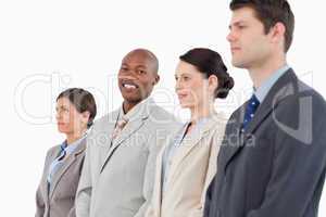 Smiling salesman standing between his colleagues