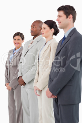 Smiling saleswoman standing next to her colleagues