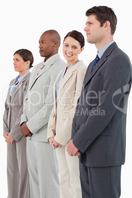 Smiling saleswoman standing between her colleagues