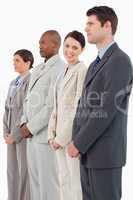 Smiling saleswoman standing between her colleagues