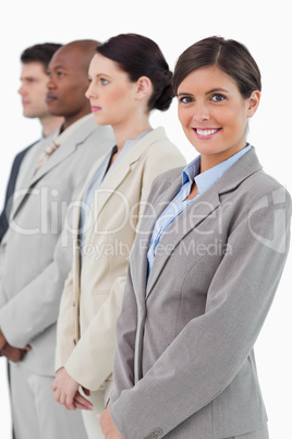 Smiling businesswoman standing next to her associates