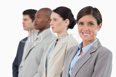 Smiling saleswoman standing next to her associates
