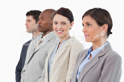 Smiling saleswoman standing between her associates