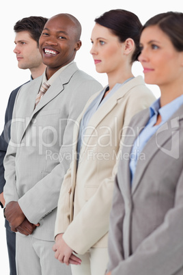 Smiling businessman standing between his associates