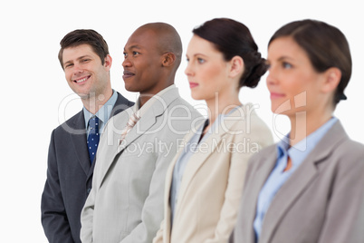 Smiling businessman standing next to his colleagues