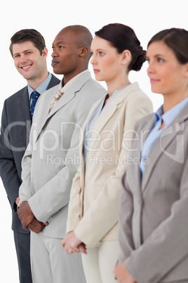 Smiling salesman standing next to his associates