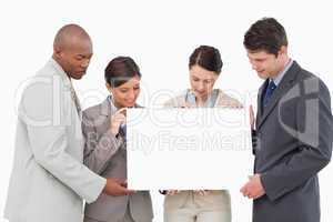 Businessteam holding blank sign together