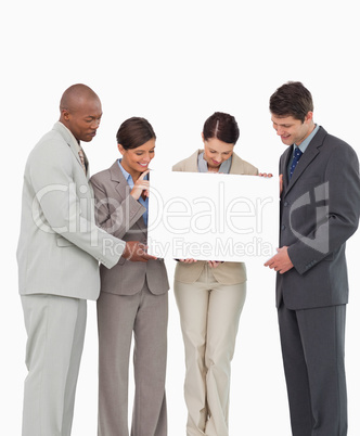 Salesteam holding blank sign together