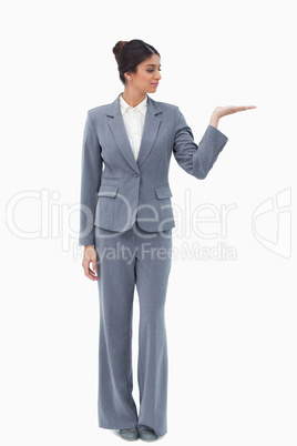 Businesswoman presenting with hand up