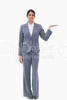 Smiling businesswoman presenting with palm up