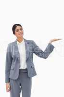 Smiling saleswoman presenting with her palm up