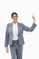 Smiling saleswoman pointing upwards