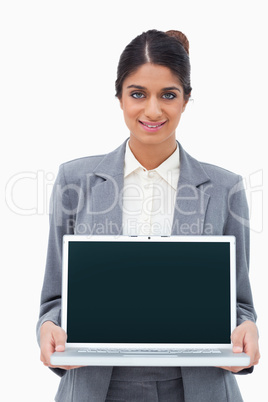 Smiling saleswoman showing screen of her laptop