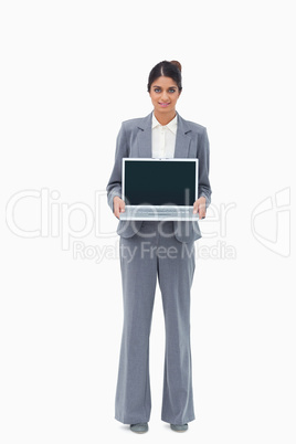 Saleswoman showing the screen of her laptop