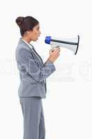 Side view of businesswoman using megaphone