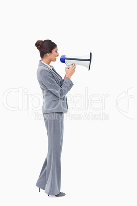 Side view of businesswoman talking through megaphone