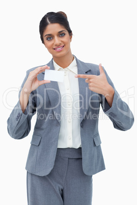 Saleswoman pointing at blank business card