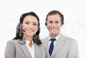 Smiling call center agents standing together