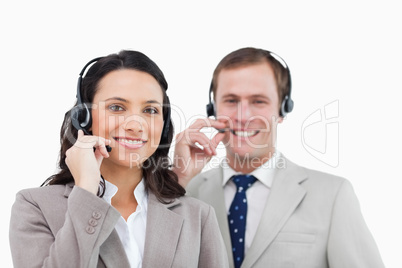 Smiling call center team with their headsets Smiling call center team with their headsets