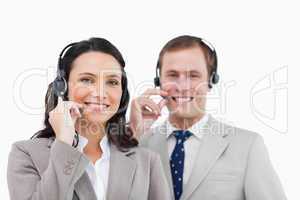 Smiling call center team with their headsets