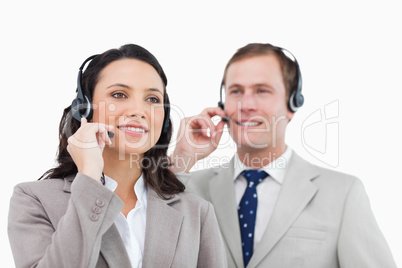Telephone help desk employees with headsets
