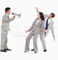 Businessman with megaphone shouting at colleagues