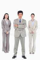 Confident businessman with his team behind him