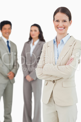 Smiling tradeswoman with employees behind her