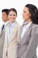 Smiling saleswoman standing between colleagues