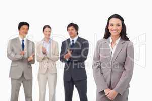 Businesswoman getting applause by colleagues