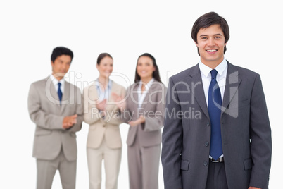 Businessman getting applause from colleagues