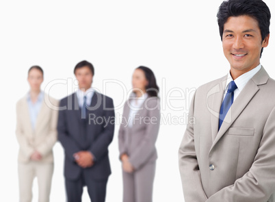 Businessman standing with his colleagues behind him