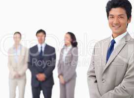 Businessman standing with his colleagues behind him