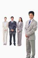 Businessman standing with his associates behind him