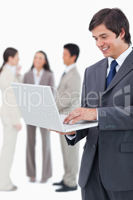 Salesman with notebook and team behind him
