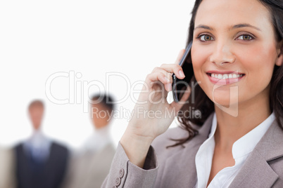 Smiling saleswoman talking on the phone