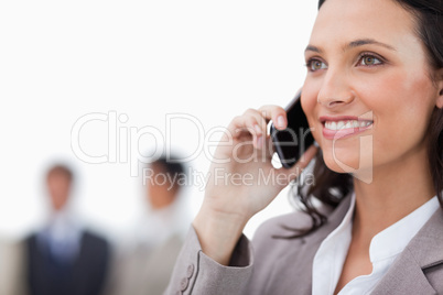 Smiling saleswoman on her phone