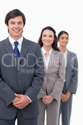 Smiling young businesspeople standing in line