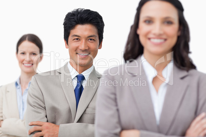 Smiling young salesteam with folded arms