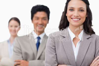 Smiling young salesteam with arms folded