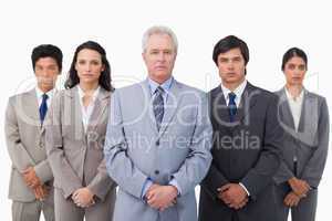 Mature businessman standing together with his team