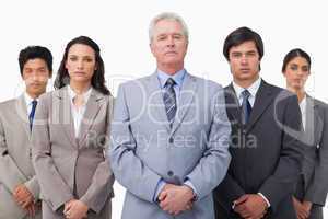 Mature businessman standing with his colleagues