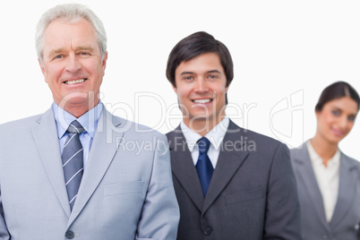 Smiling mature salesman with his employees