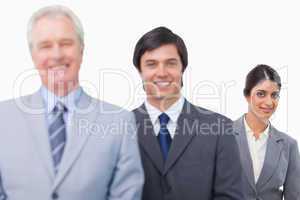 Smiling mature businessman with his employees