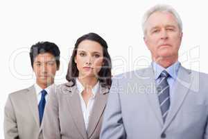 Mature businessman standing with colleagues