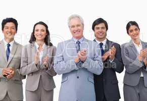 Senior businessman and his team applauding